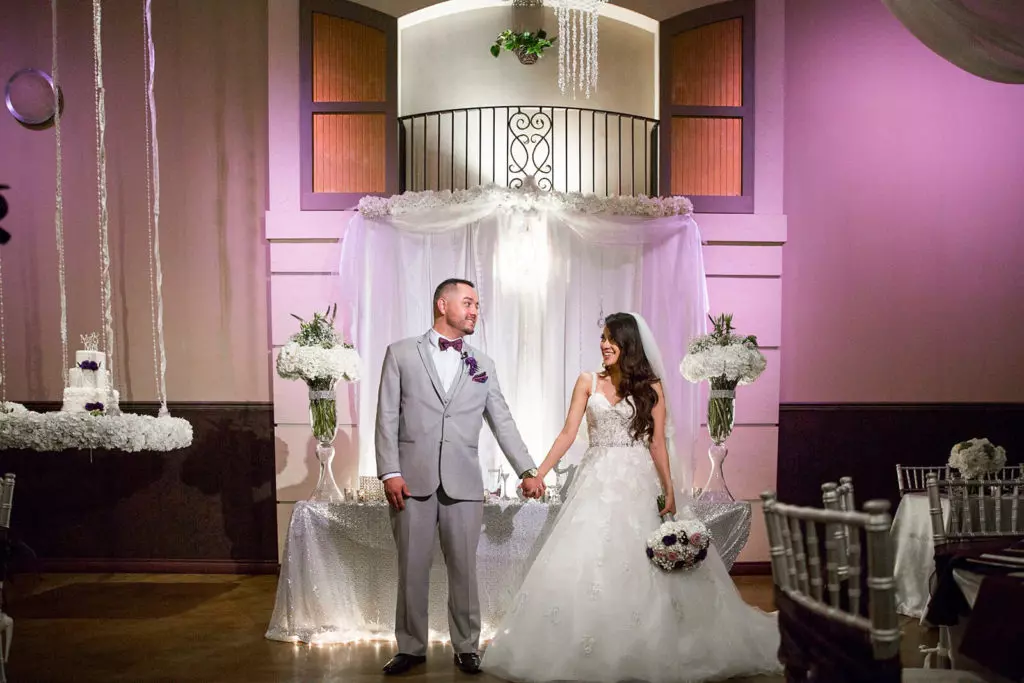 Pink colored lighting enhances wedding reception 