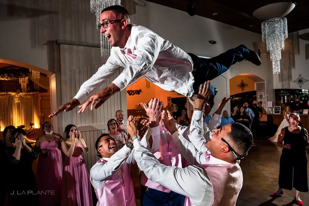 Tossing the groom in the air on the dance floor