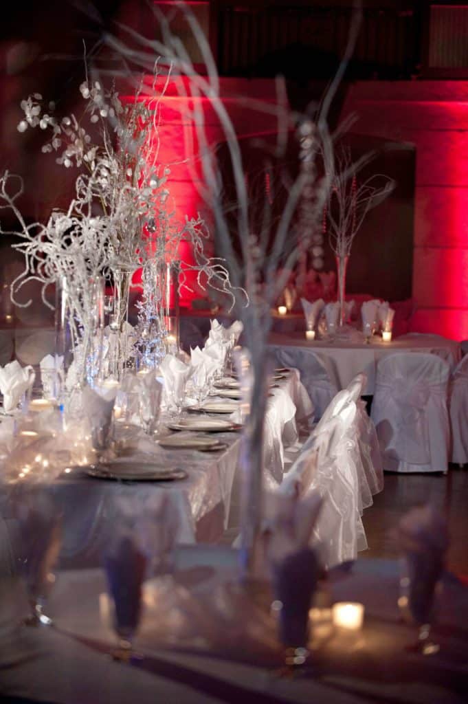 Indoor wedding venue winter decor with red lighting