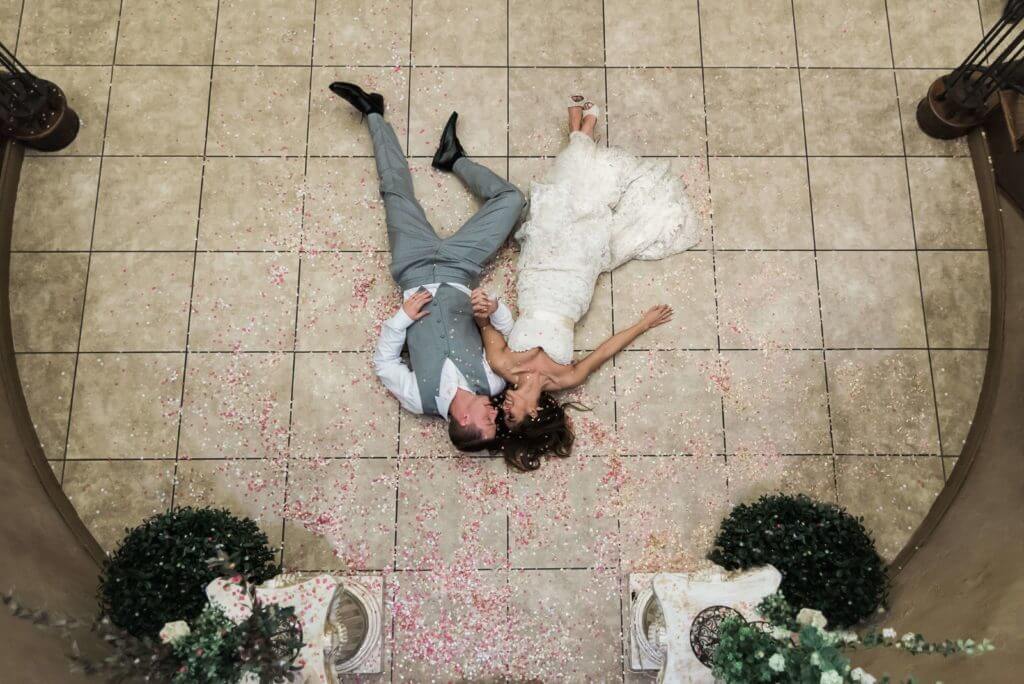 Couple-laying-on-Lobby-floor-in-petals-1024x684