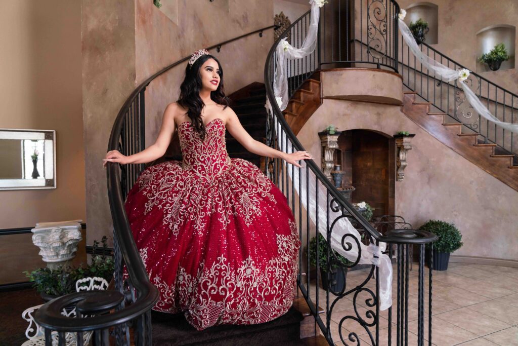 A young girl at her quinceanera on the grand staircase of the Bella Sera, a unique wedding and event venue in Colorado.